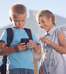 Boy and Girl looking at a cellphone